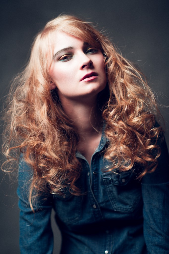 Headshot Photography in Hudson Valley Heidi in Jeans on Deep Grey backdrop studio shot