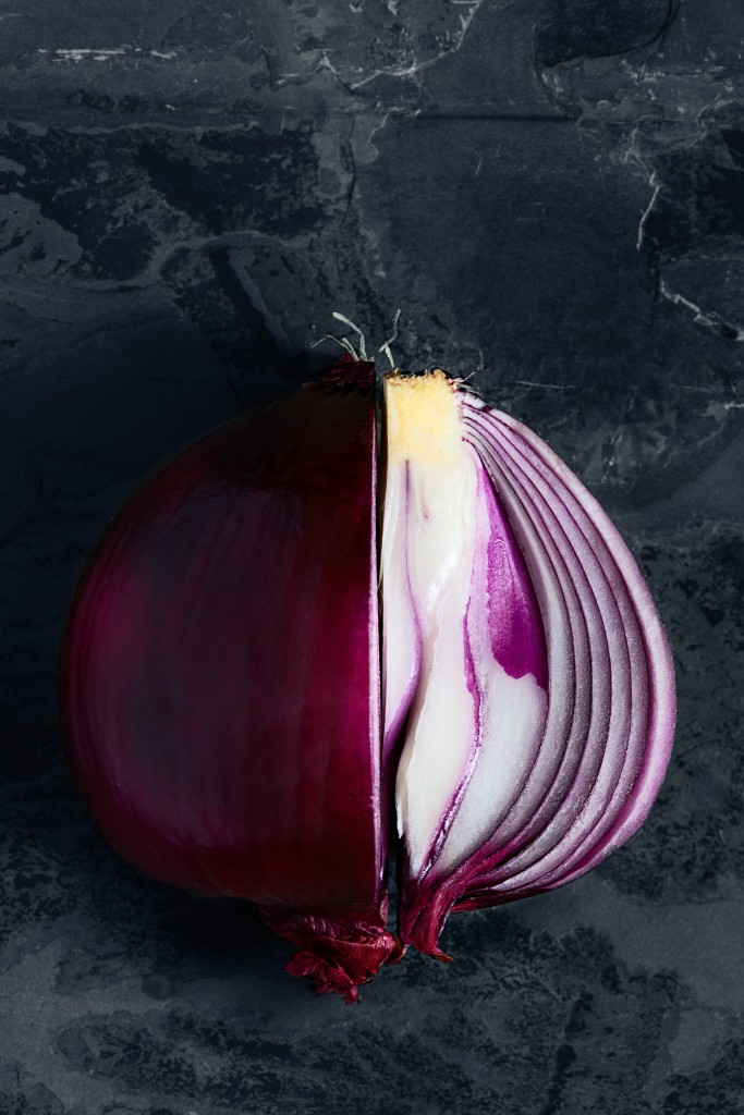 Onion on Black slate purple colors and blue background